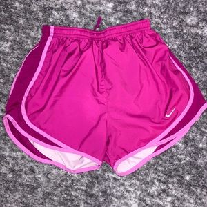 Nike athletic shorts, color pink, woman’s size small, says run on the back